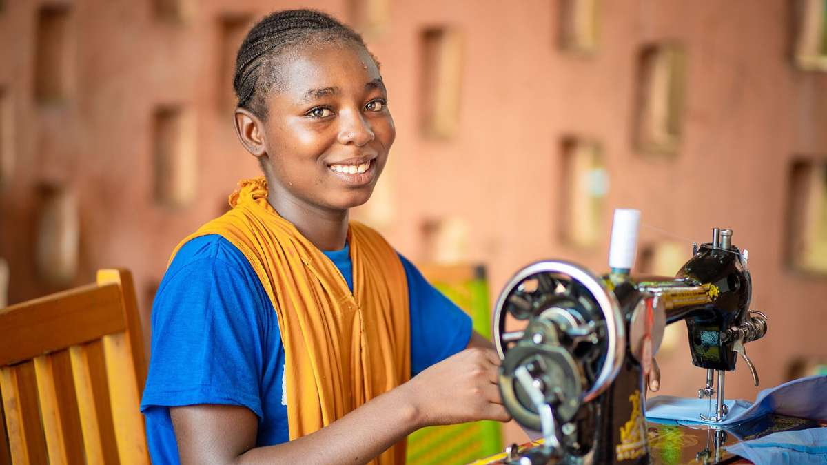 Woman Sewing a dress as part of vocational skills
